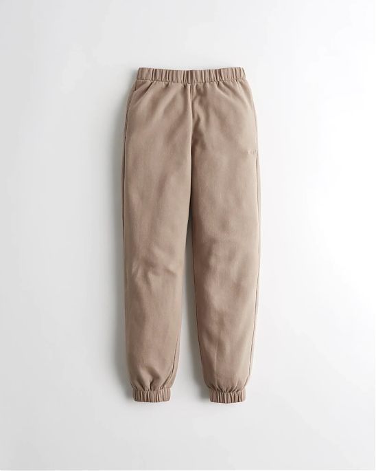 Женские спортивные штаны Hollister Dad Joggers светло-коричневого цвета с нашитым логотипом в виде чайки. Модель 06059. Подробное описание и цена товара. Доставка по России, Москве и Области от Moscow USA