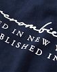 Moscow USA предлагает вам купить футболку Abercrombie Fitch темно-синего цвета с белой надписью на груди и спине. Модель 05692. Доставка по России, Москве и области, самовывоз